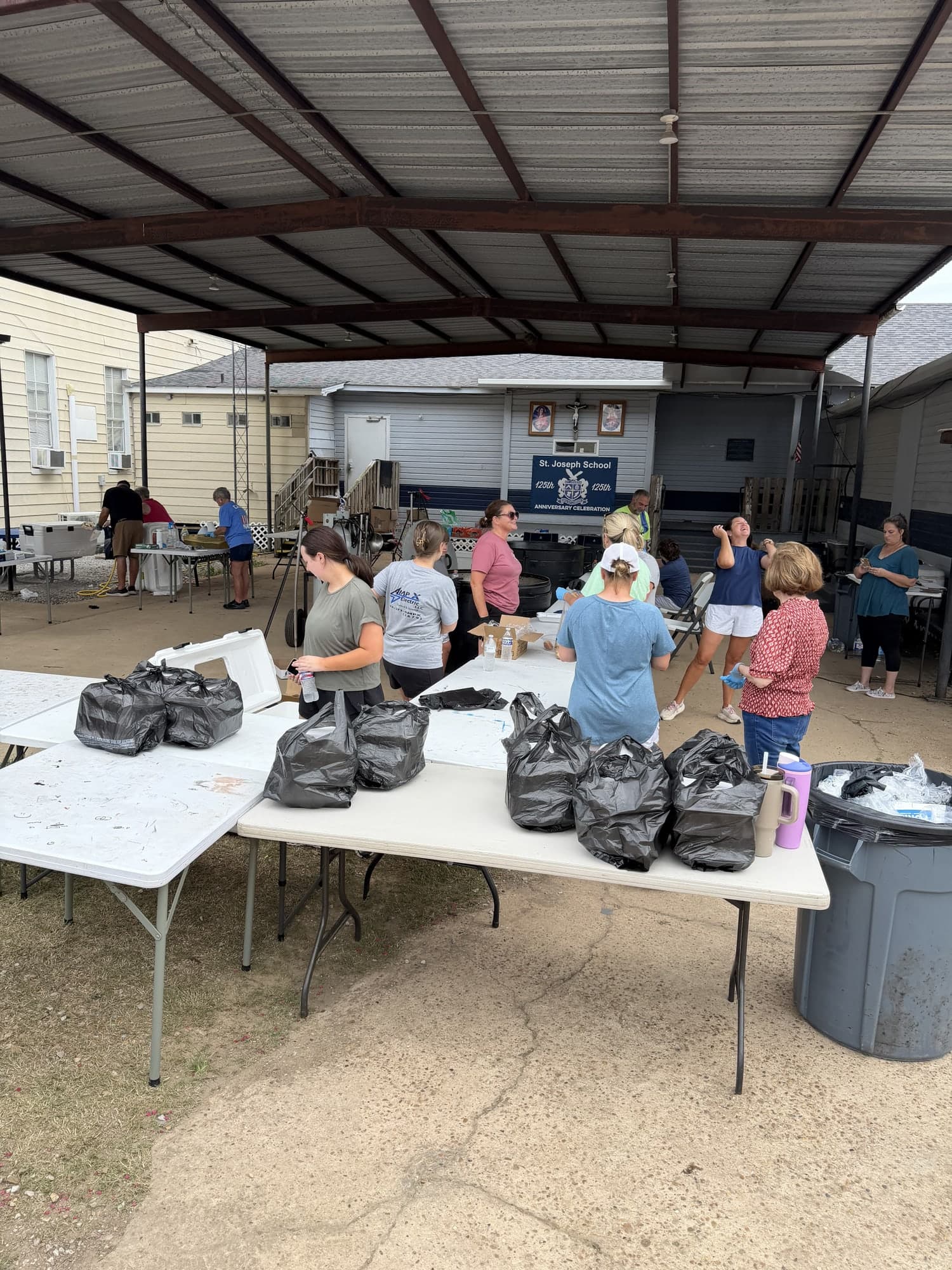Volunteers preparing supplies at an outdoor community event