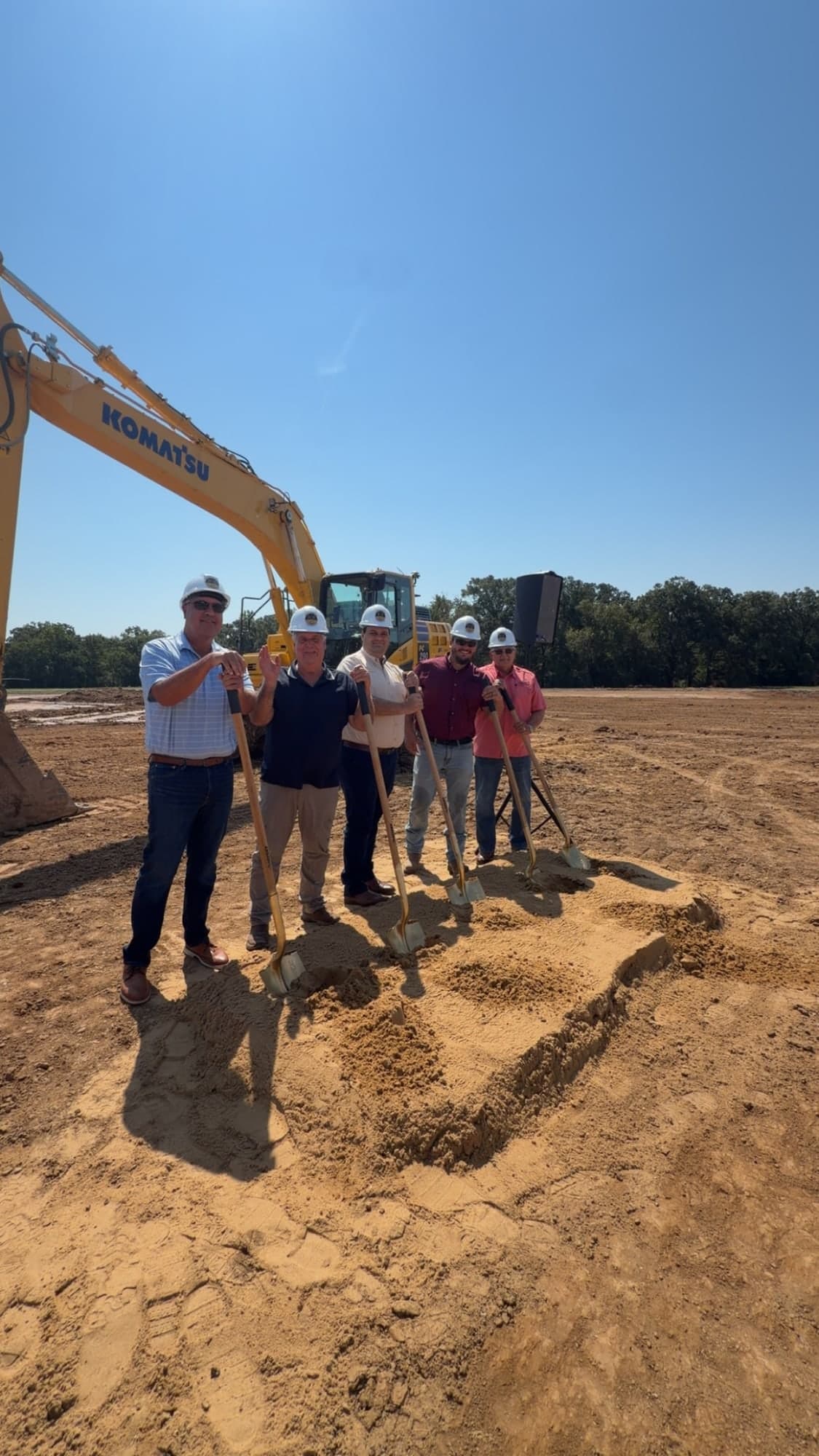 Local leaders with shovels at a construction site
